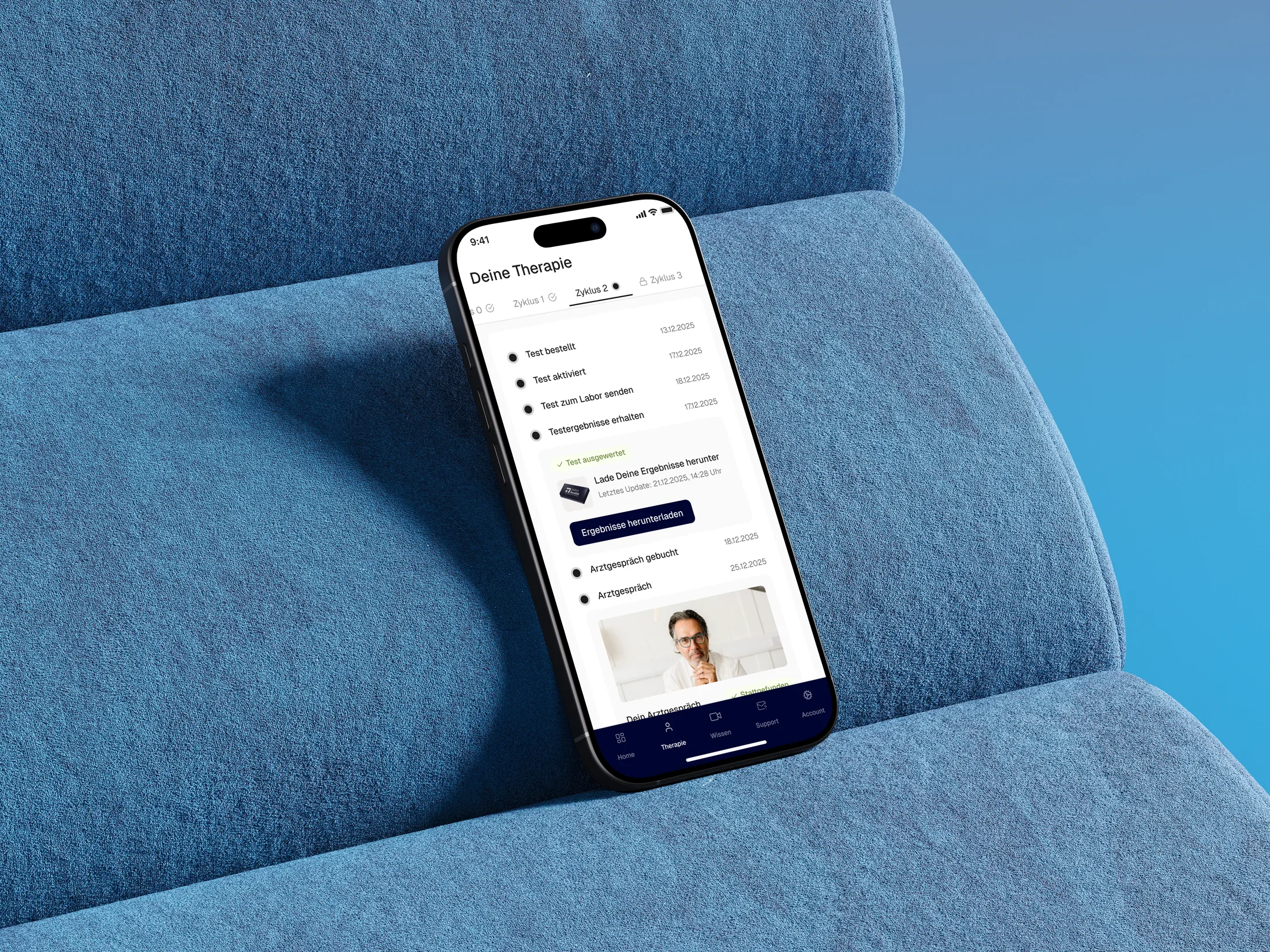 The Adon Health therapy timeline displayed on a phone resting on a blue upholstered chair