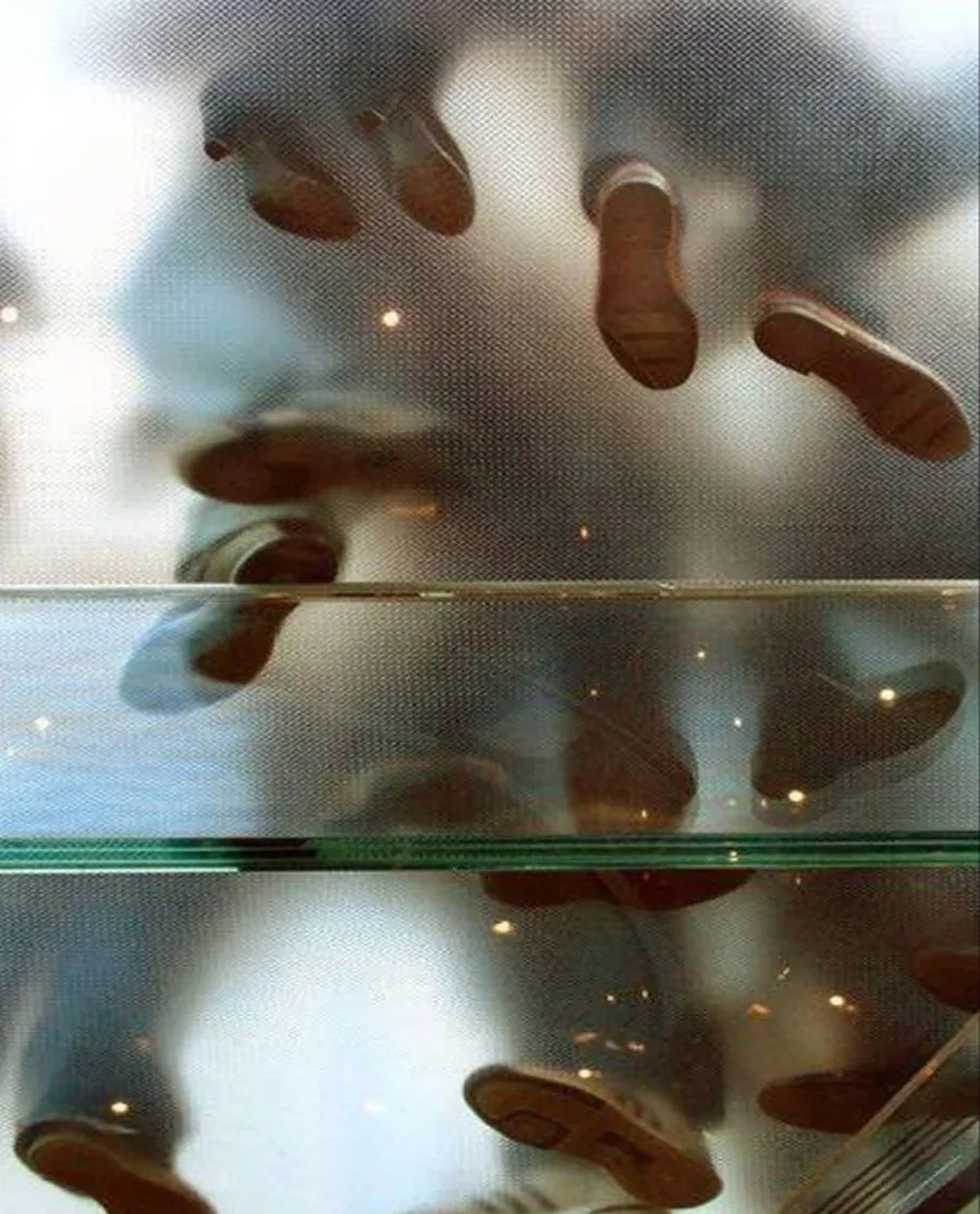 Footsteps seen from below through a glass floor